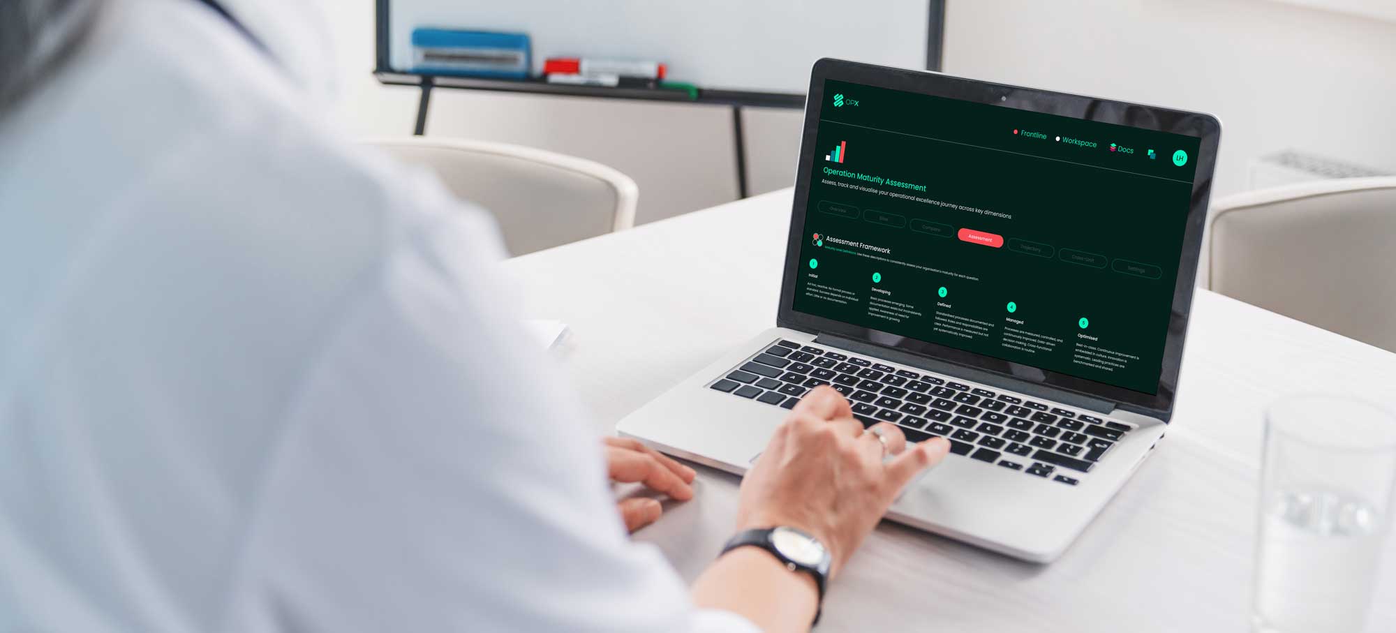 Healthcare professional reviewing OpX maturity dashboard on mobile